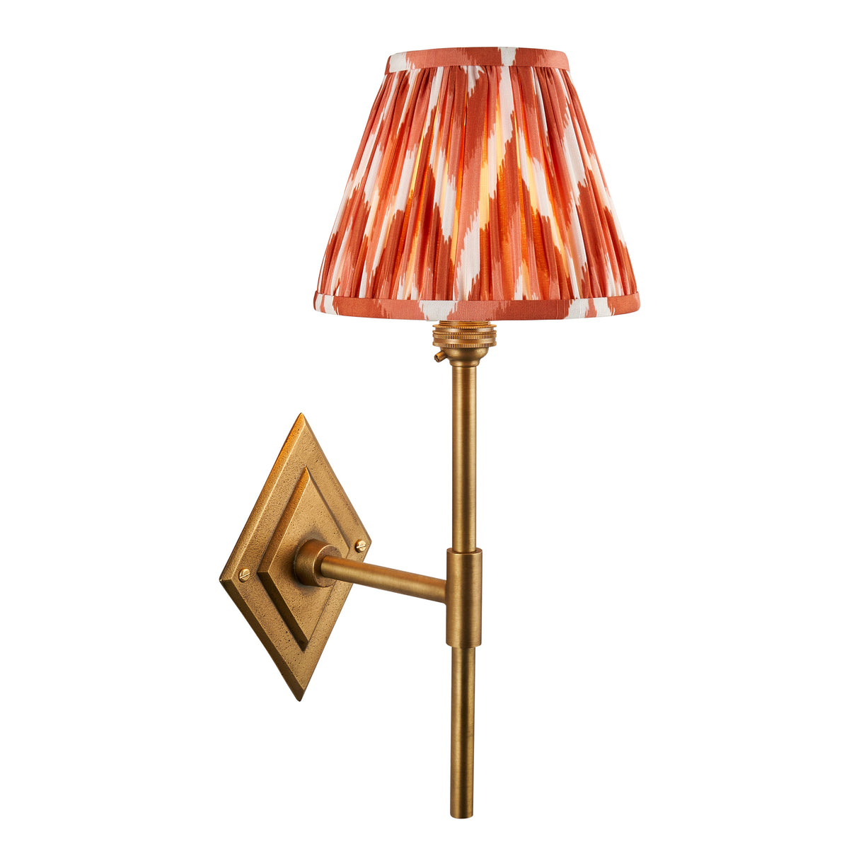 Diamond Tall antique brass wall light with orange ikat pleated shade on a diamond backplate
