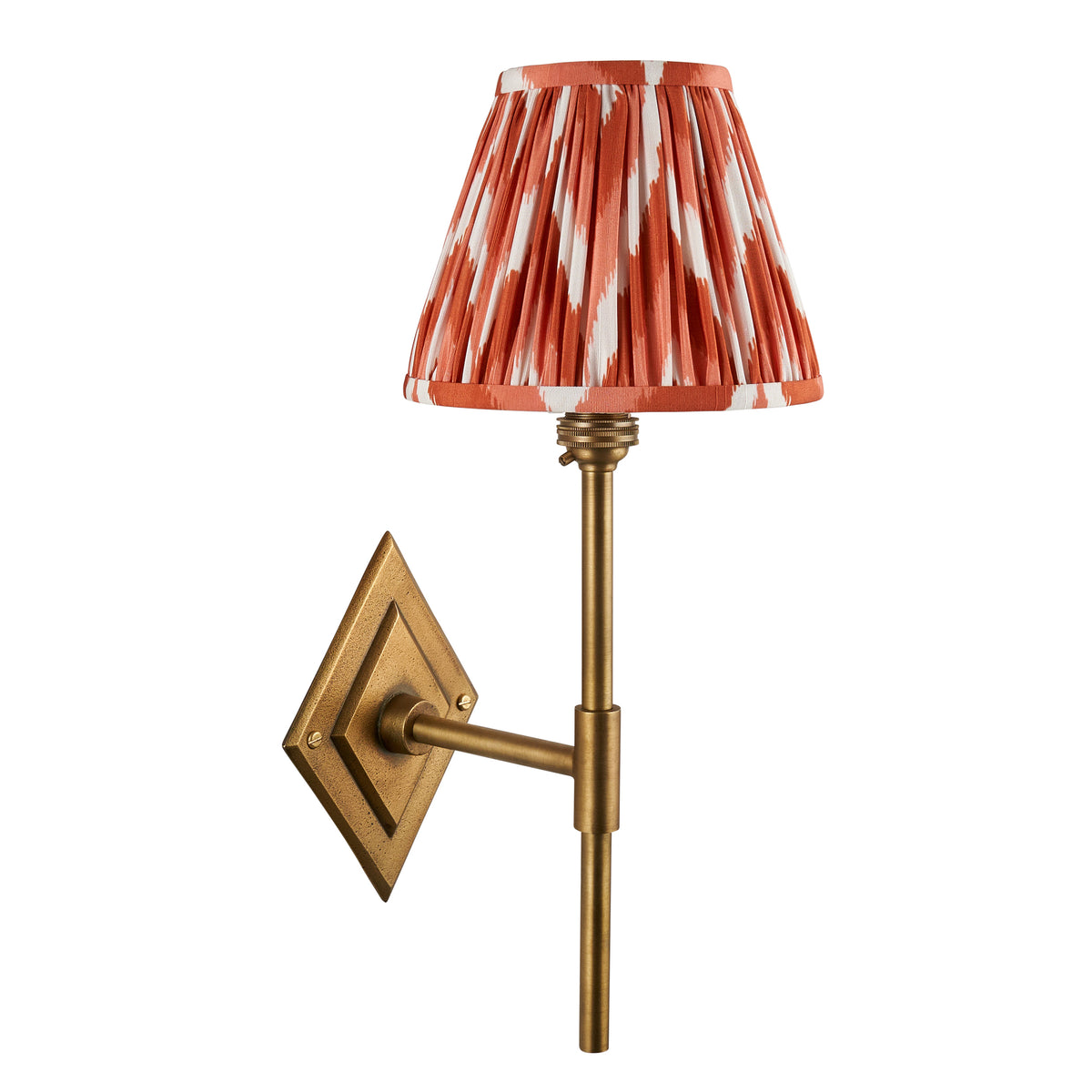 Diamond Tall antique brass wall light with orange ikat pleated shade, cut out on white background