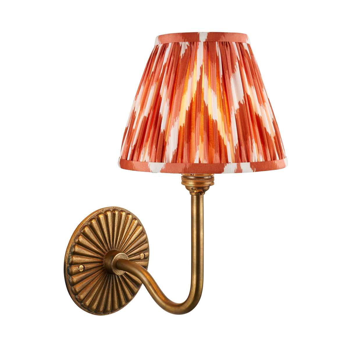 Dahlia Swan antique brass wall light with orange zigzag ikat pleated shade on white background