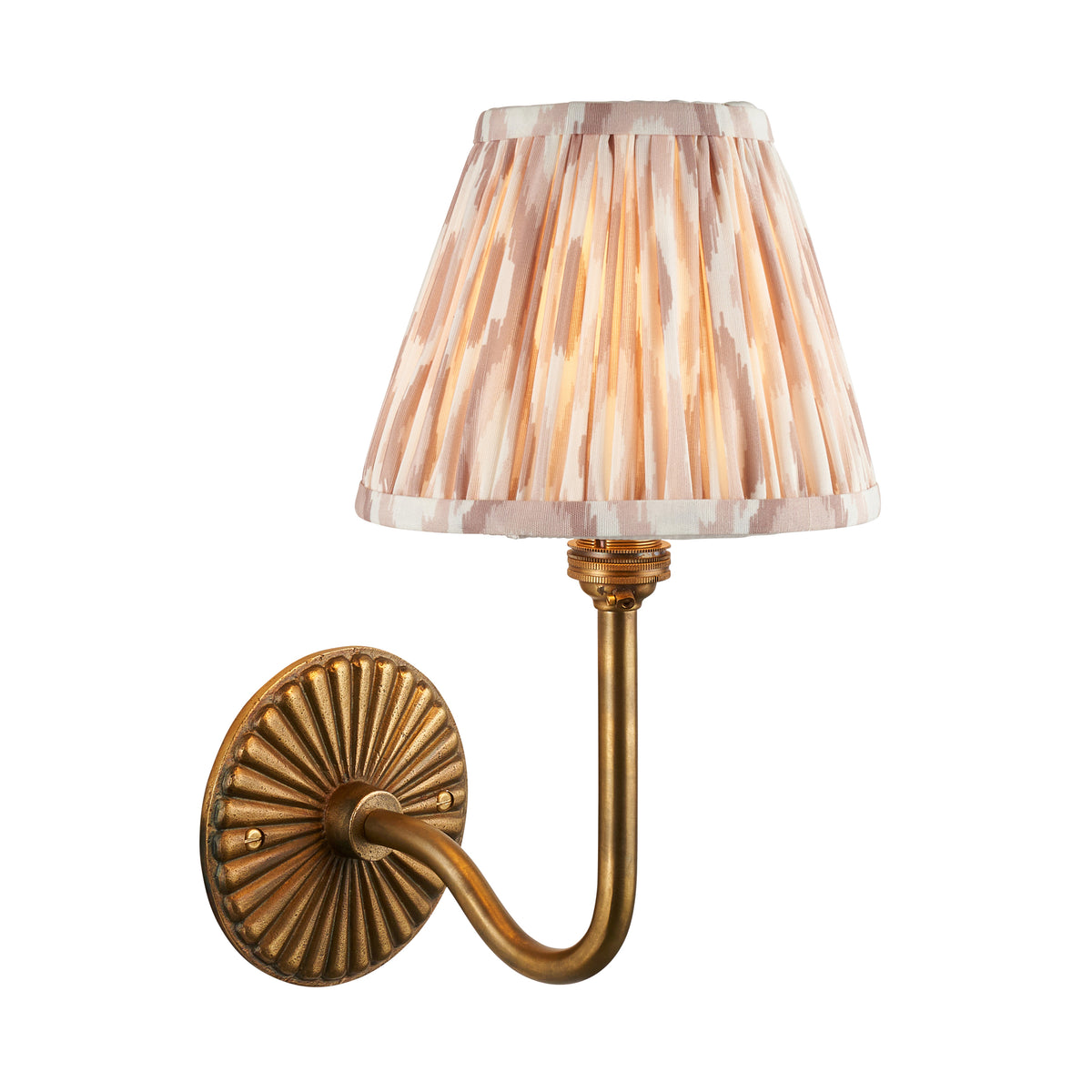 Dahlia Swan antique brass wall light with natural ikat pleated shade on a white background