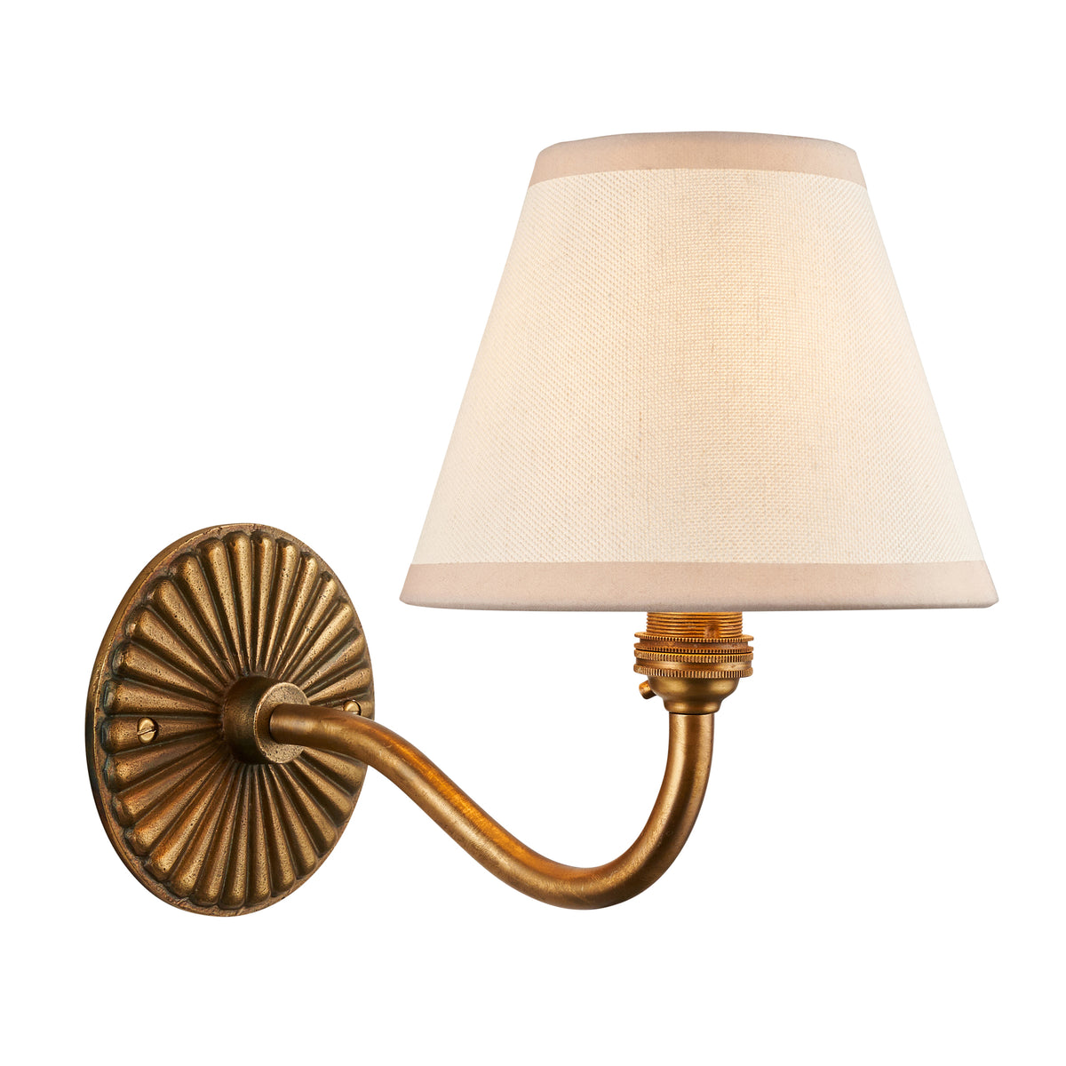 Dahlia Curve & Ivy antique brass wall light with a tapered ivory fabric shade and fluted oval backplate