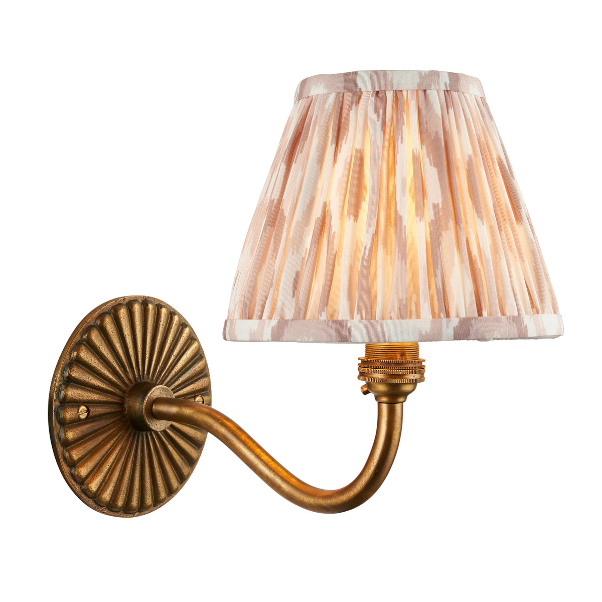 Dahlia Curve antique brass wall light with a pleated natural ikat shade in soft beige and cream