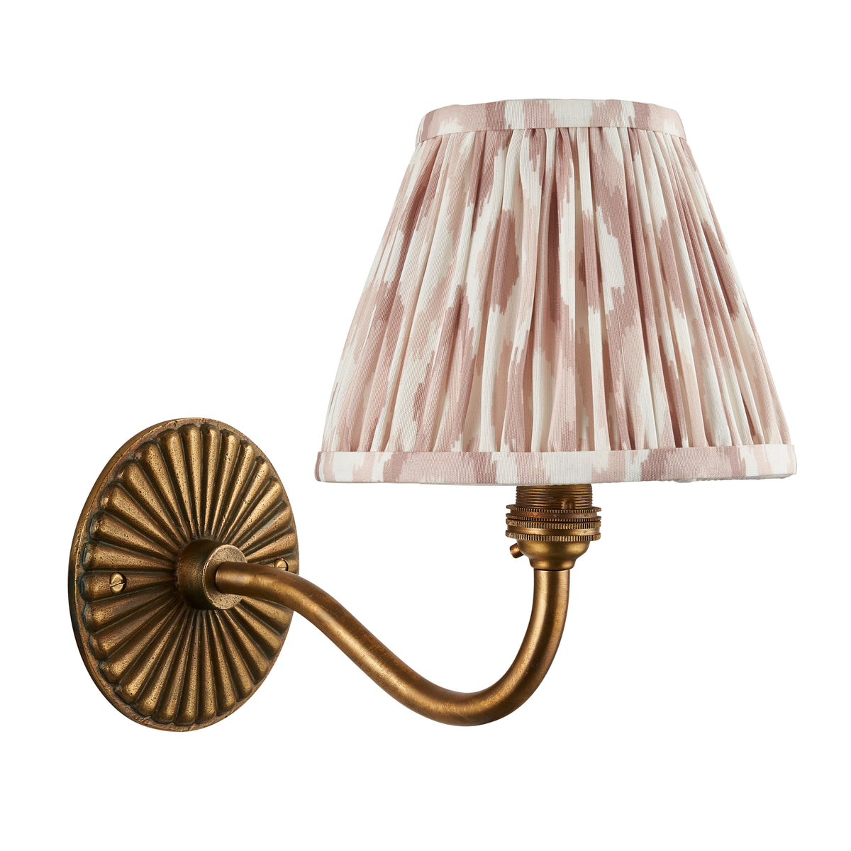 Dahlia Curve brass wall light with soft pink-beige ikat pleated shade on a white background