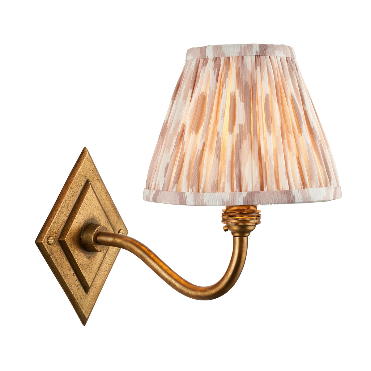 Diamond Curve antique brass wall light with a pleated natural ikat shade in soft beige and cream