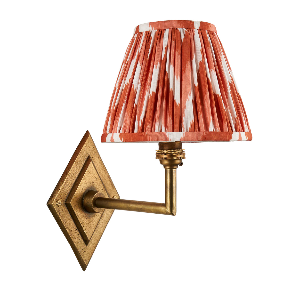 Diamond Angle antique brass wall light with orange ikat pleated shade, unlit studio shot
