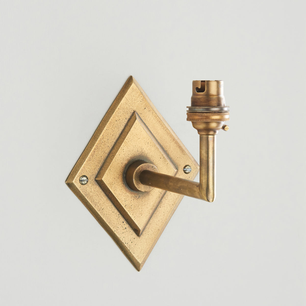 Diamond Angle antique brass wall light without a shade, showing backplate, arm and lampholder