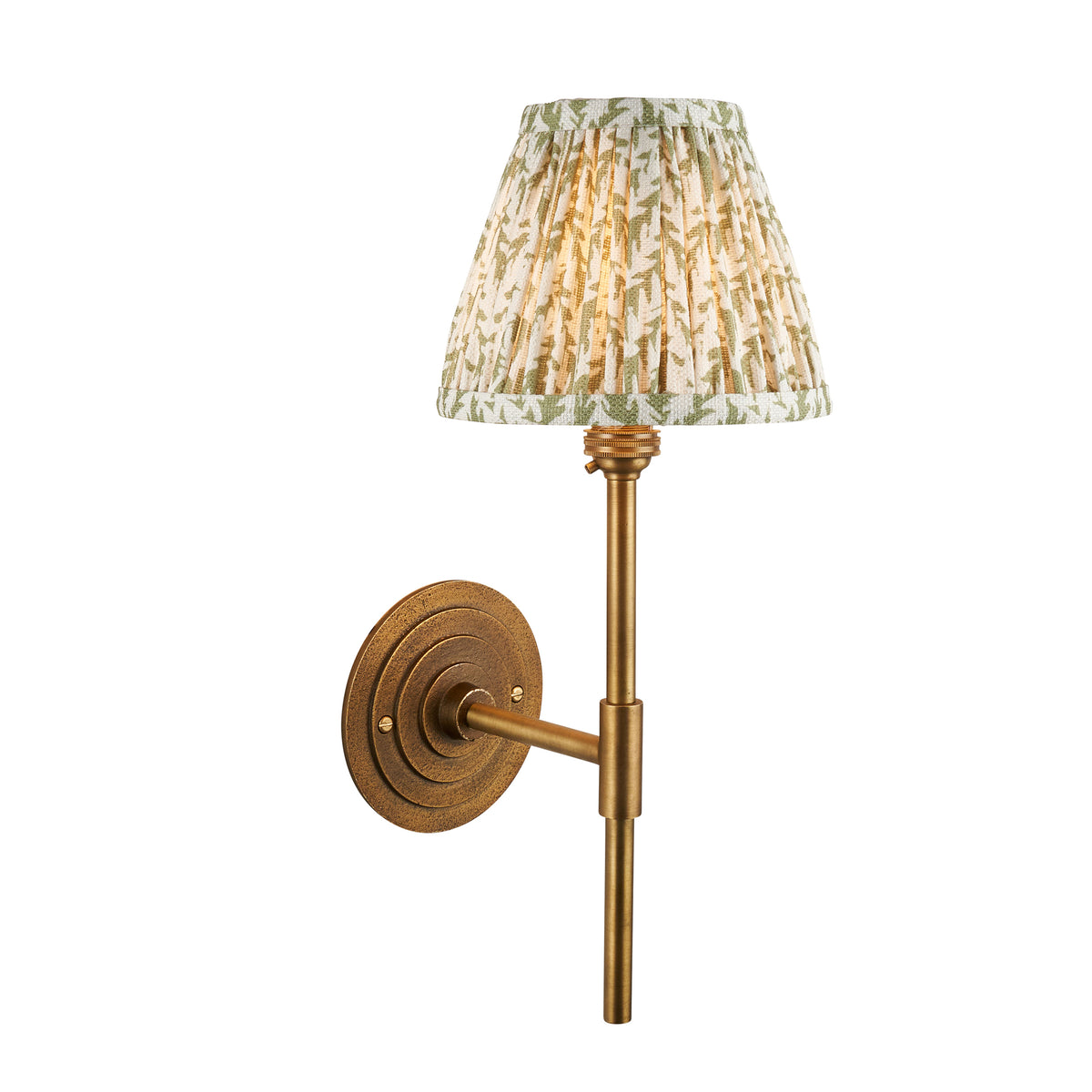 Halo antique brass wall light on a slim stem with a pleated green leaf-print shade