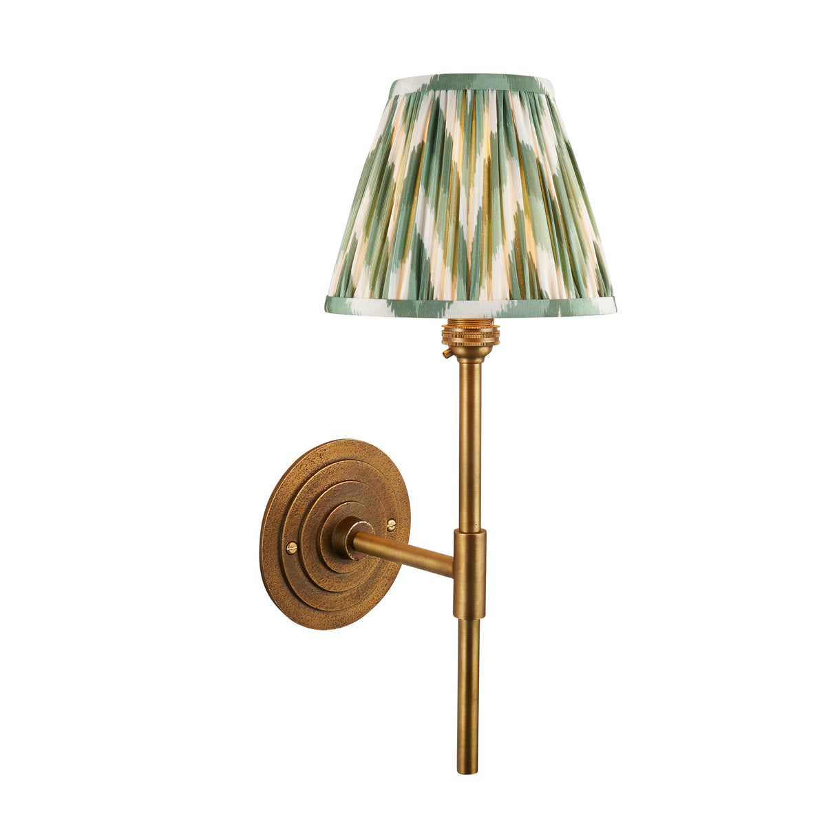 Halo Tall antique brass wall light with a pleated green zigzag ikat shade on a slim stem