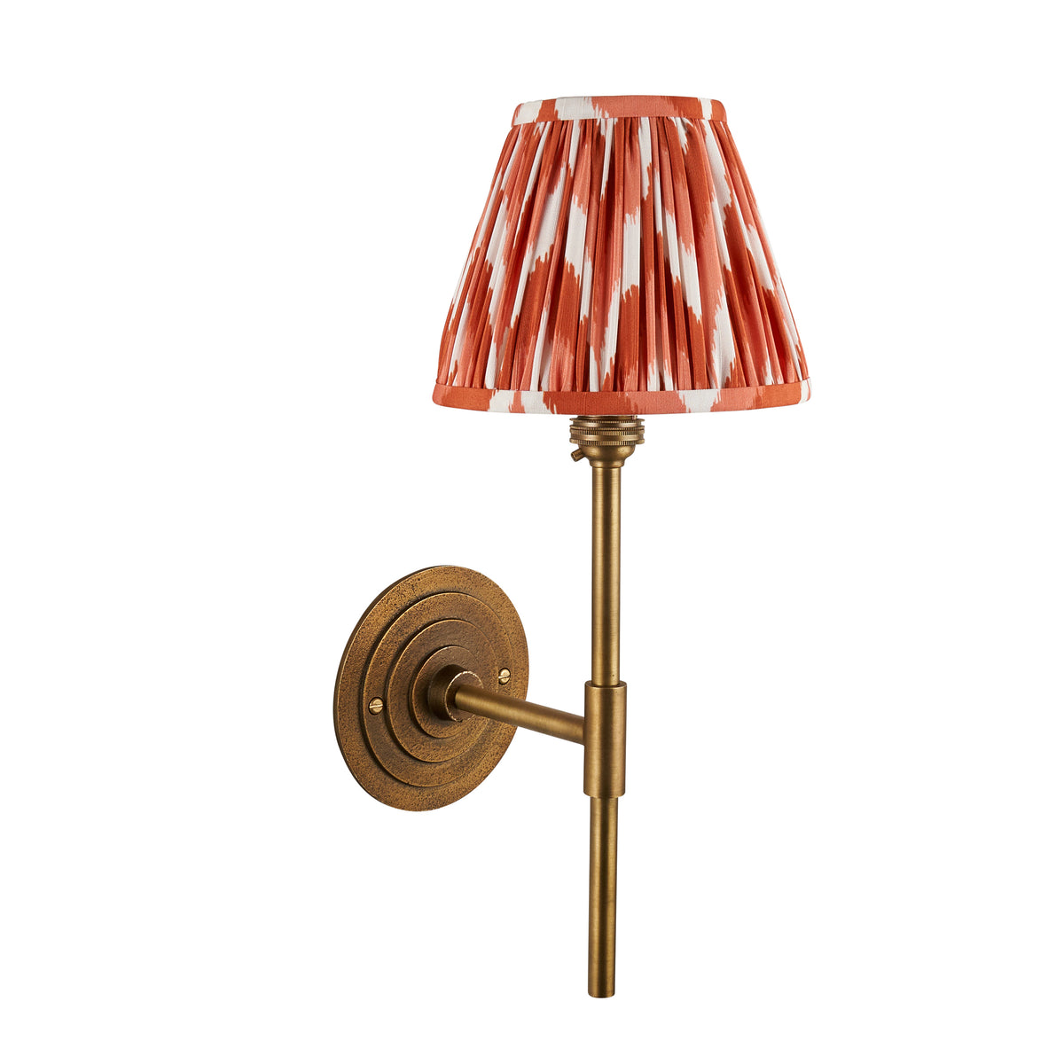 Halo antique brass wall light fitted with an orange zigzag ikat pleated shade, unlit