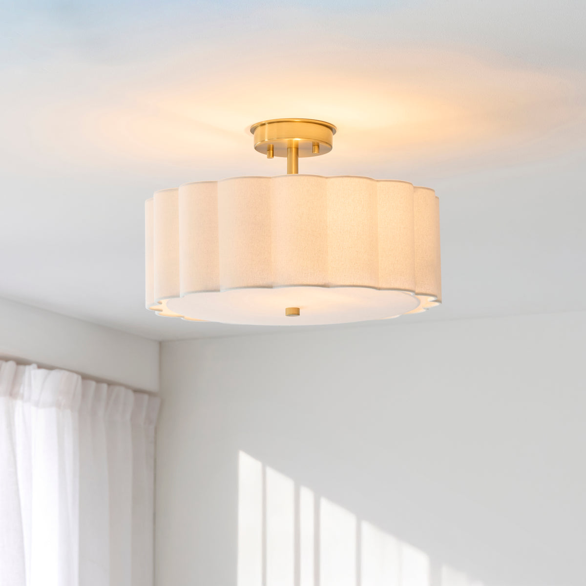 Serene flush ceiling light lit in a bright room with white curtains and sunlit wall