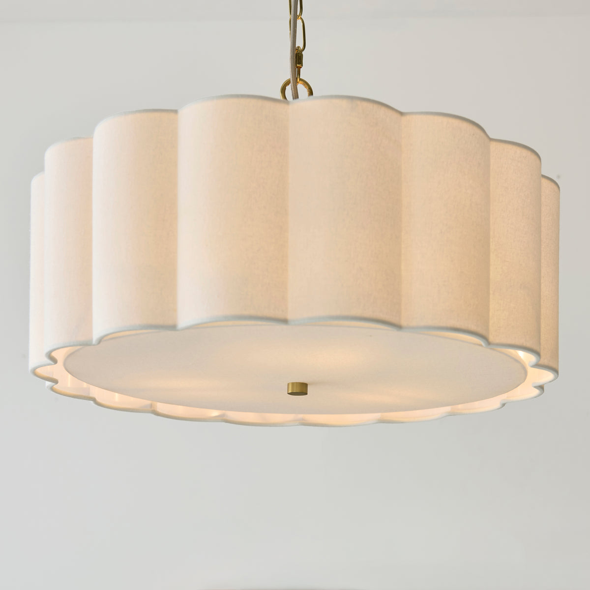 Underside of the Serene pendant showing the scalloped cream shade and glowing fabric diffuser