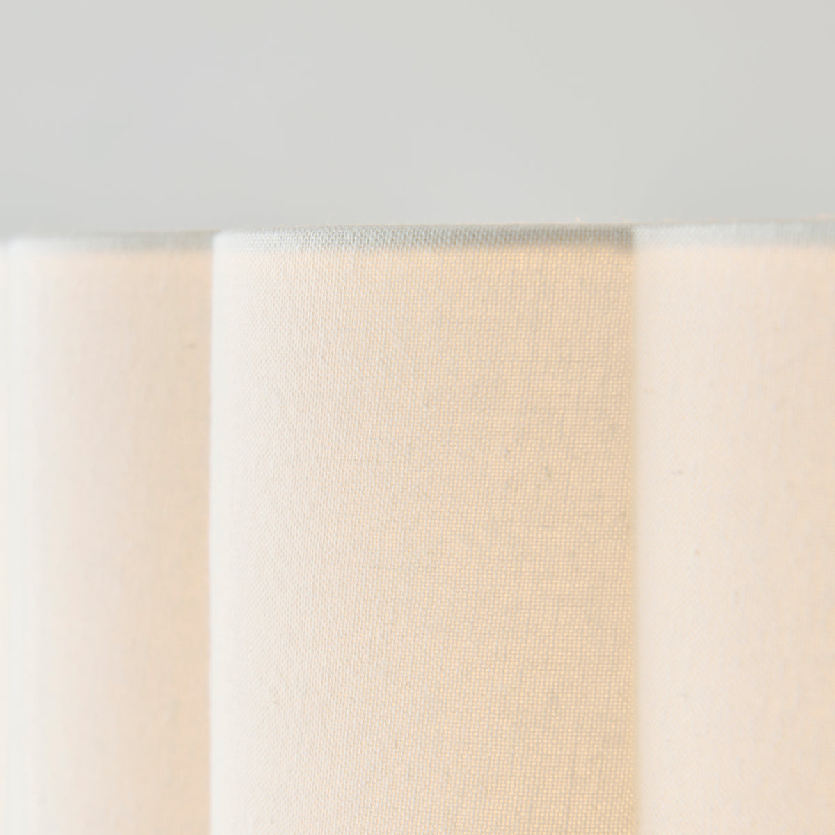 Close-up of the fluted cream cotton shade fabric with soft vertical folds