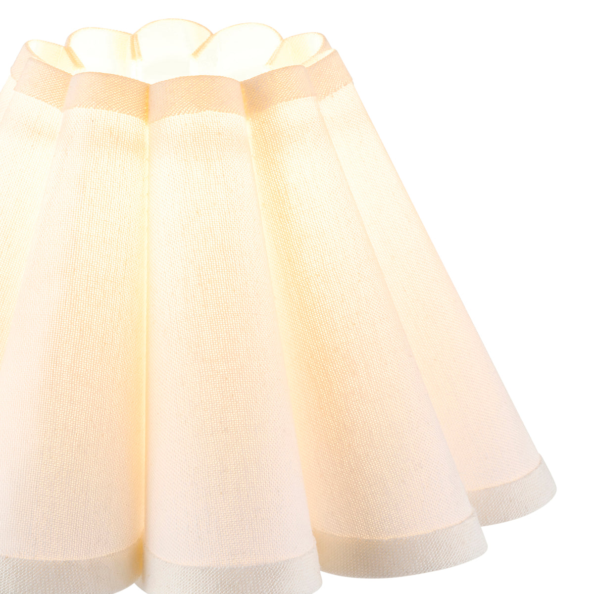Close-up of the Ayla shade's fluted panels and scalloped trimmed edge, lit from inside