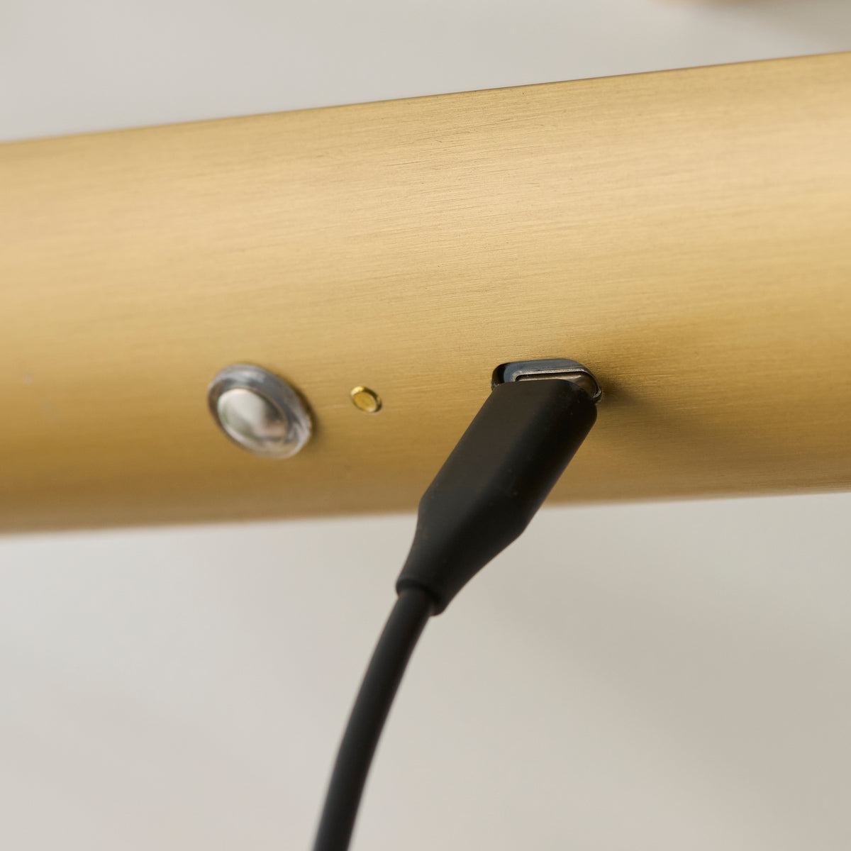USB charging port and power button on the brass body of the Nantes rechargeable picture light