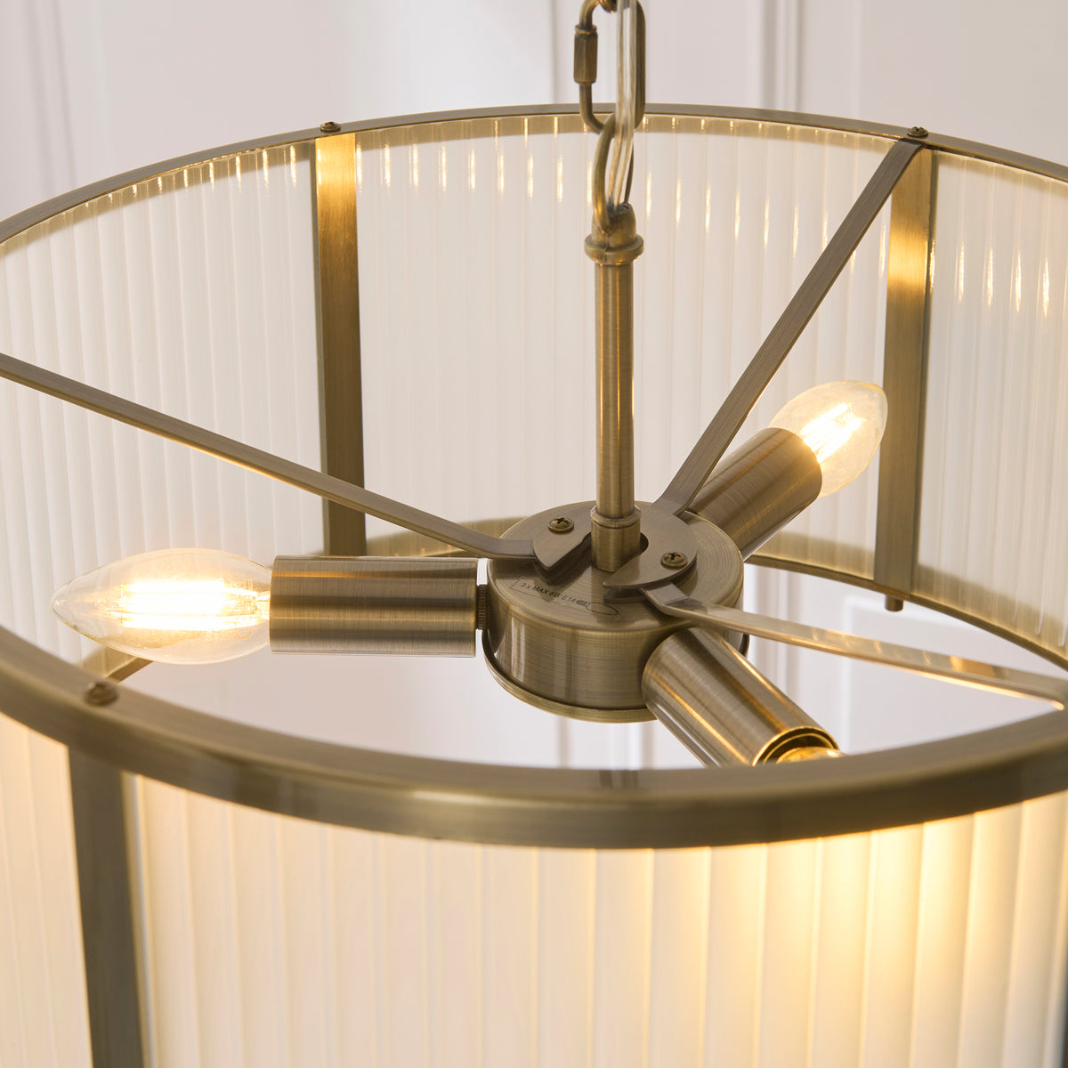 Interior of the Ridgeton pendant showing three brass lampholders with lit filament bulbs