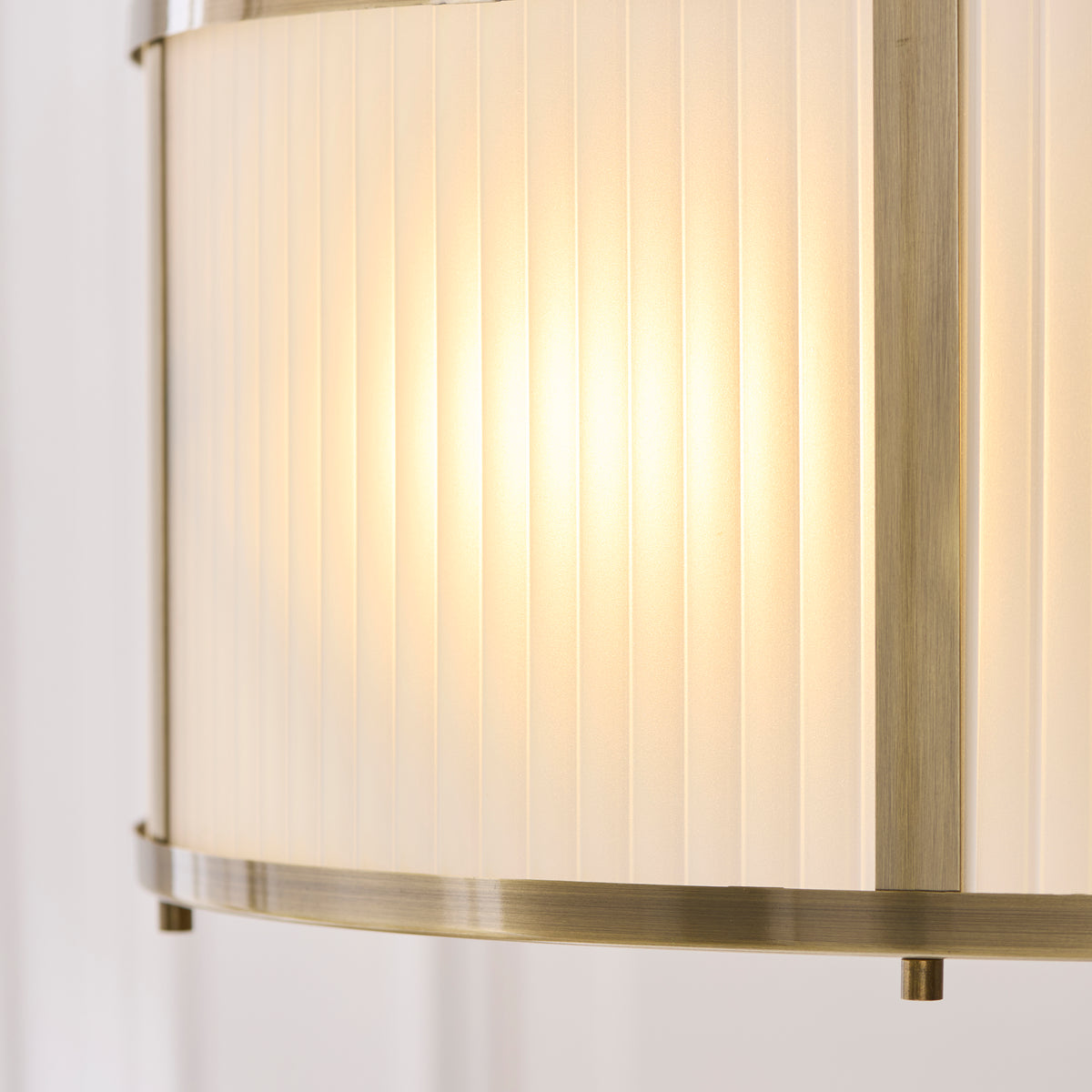 Close-up of the ribbed glass panels and antique brass trim on the Ridgeton pendant shade