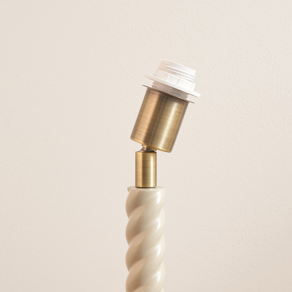 Detail of the Twist table lamp base showing its brass fitting above the twisted column