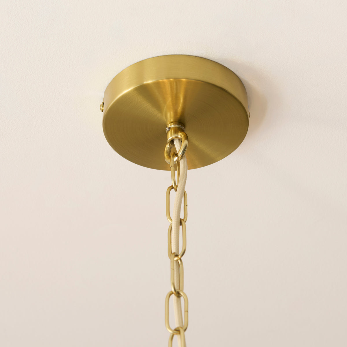Brushed brass ceiling rose and chain of the Noah tiered pendant light