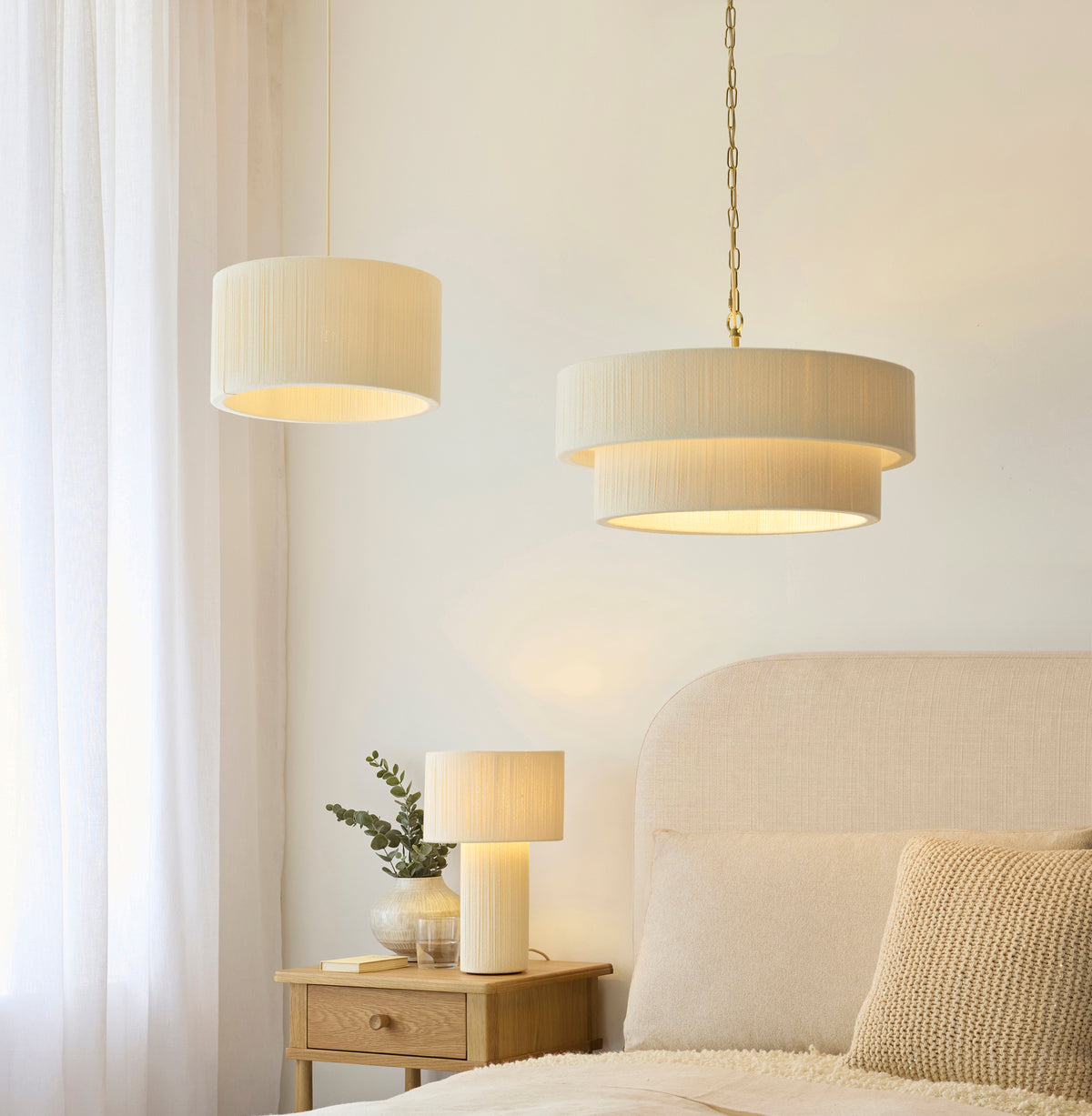 Noah tiered pendant, second pendant and matching table lamp lit in a serene bedroom
