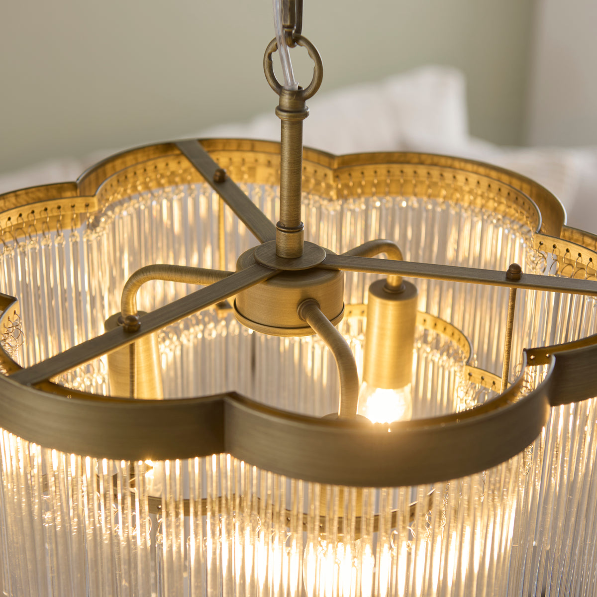 Interior of the Lucille chandelier showing brass arms, lamp holders and lit bulb