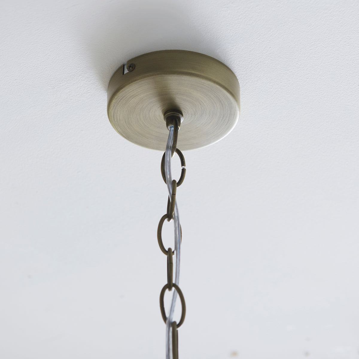 Antique brass ceiling rose and chain of the Lucille 5 light chandelier