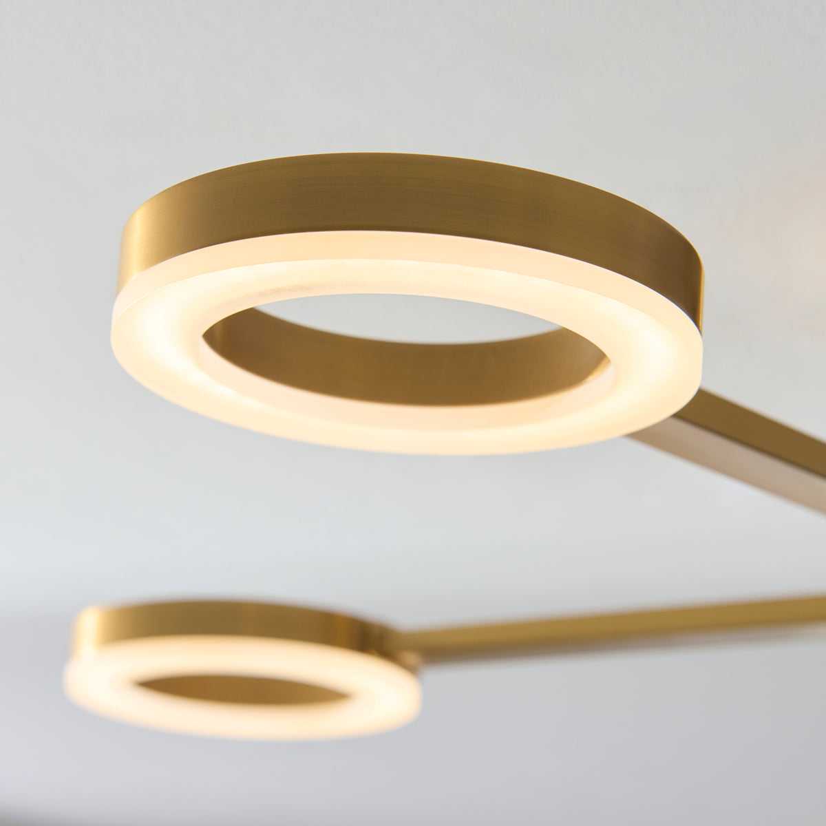 Detail of a Scout LED ring with warm brass edge and softly lit diffuser