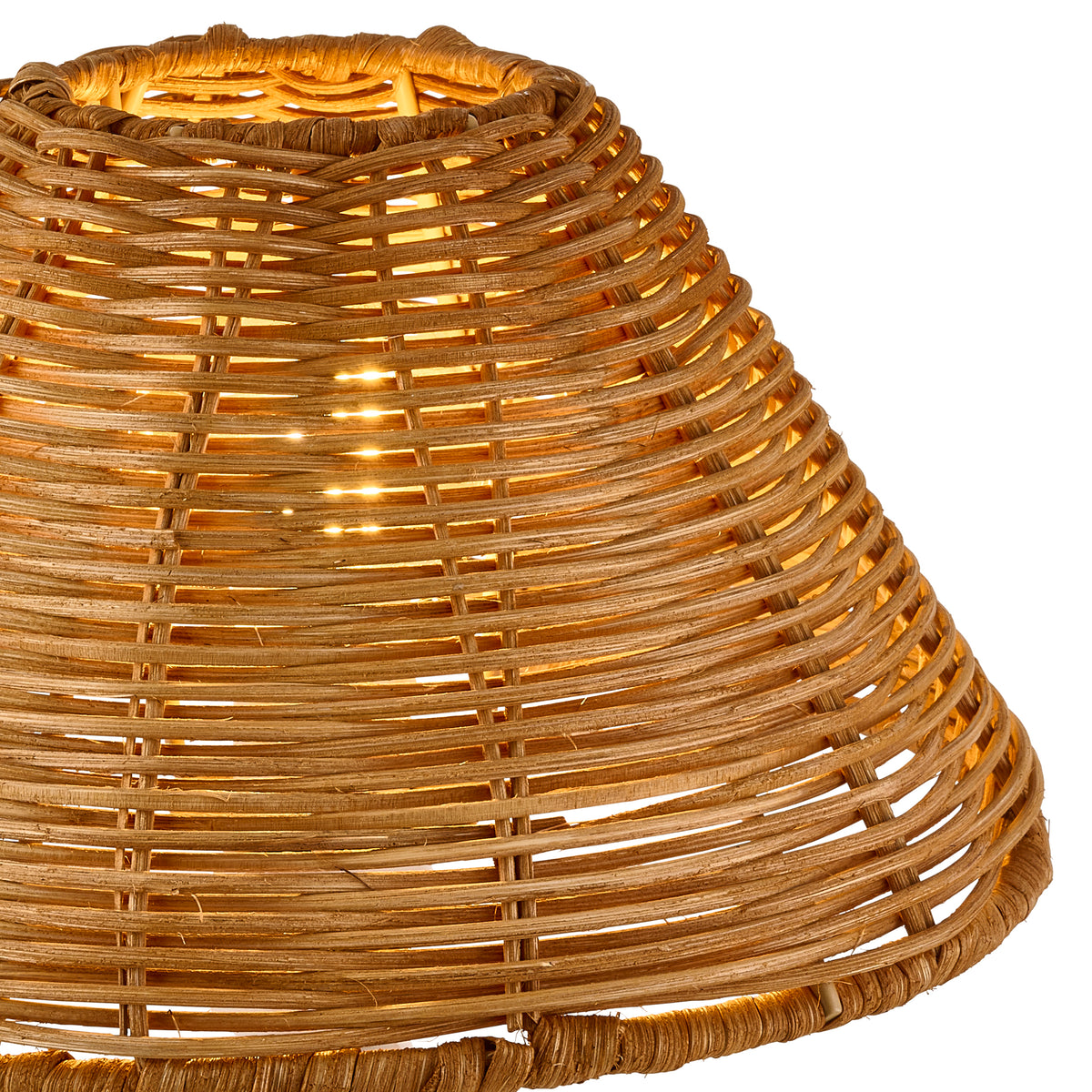 Illuminated dark rattan shade in close-up, revealing the woven cane rows and warm glow