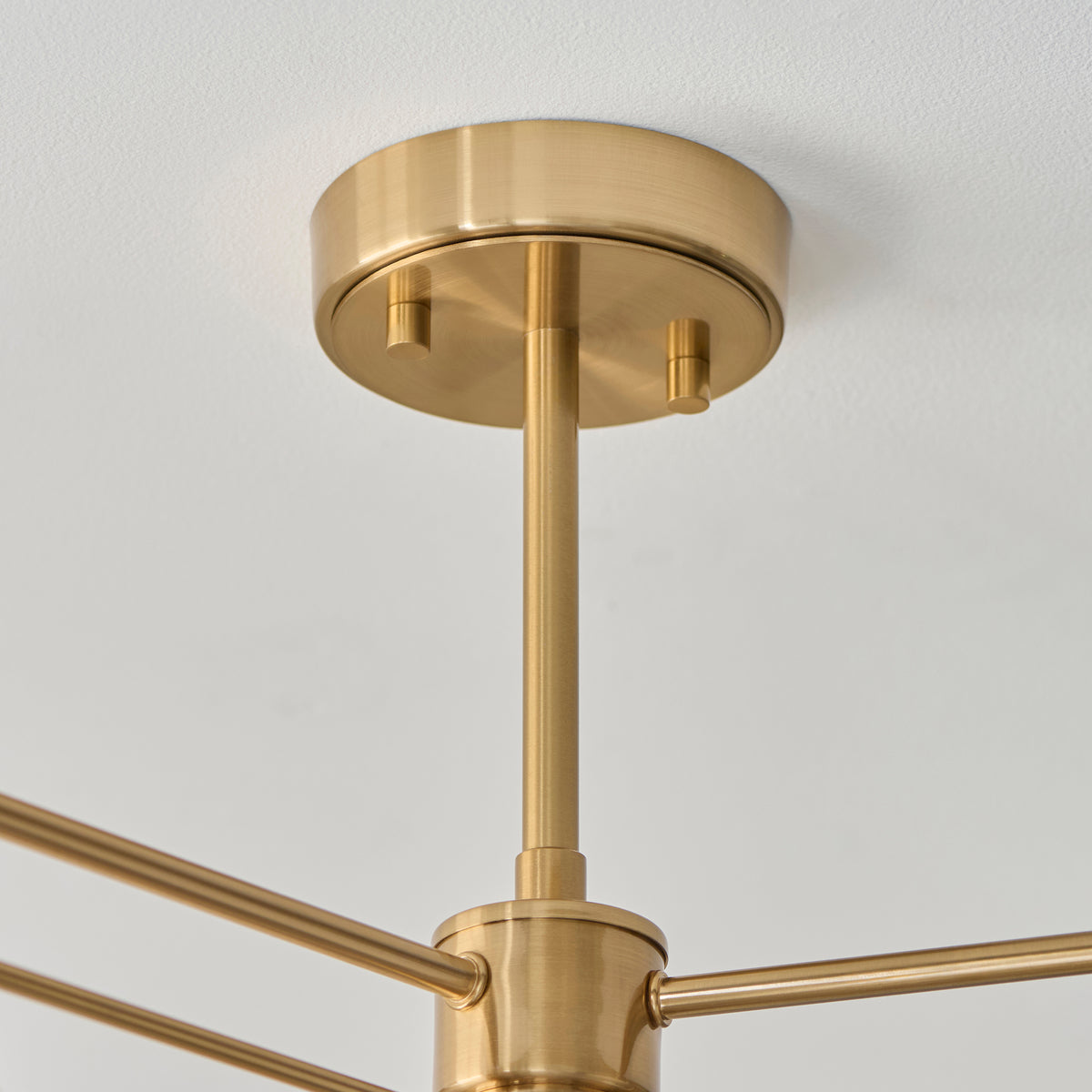 Detail of the Wallbridge light's aged brass ceiling plate, stem and arm junction