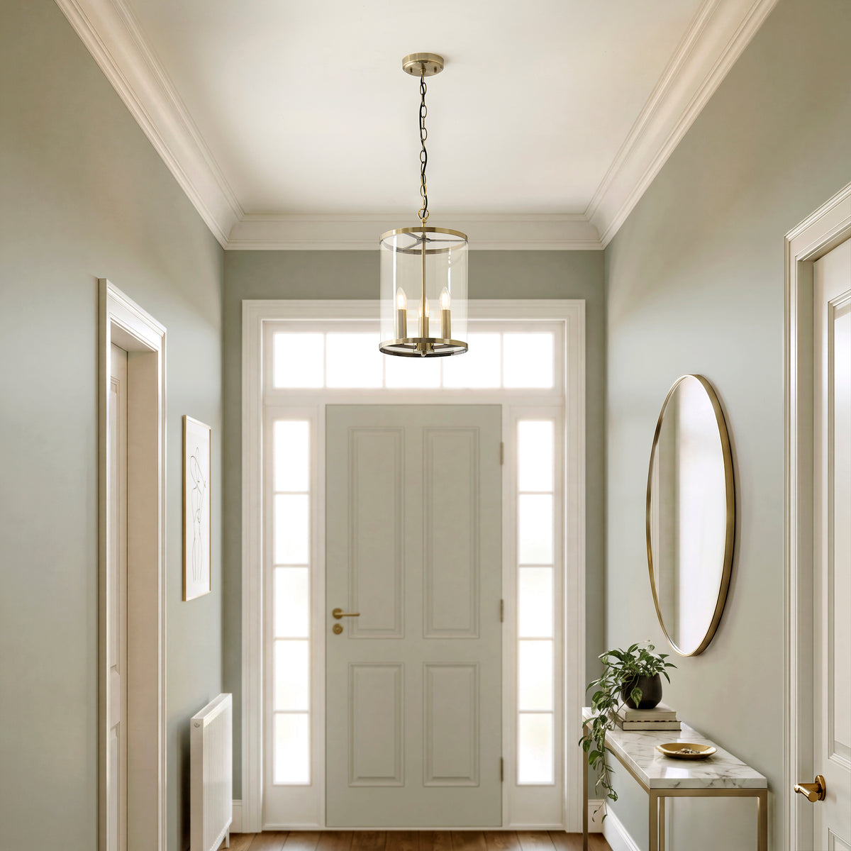 Hebden brass lantern pendant lighting a sage green hallway with panelled door and oval mirror