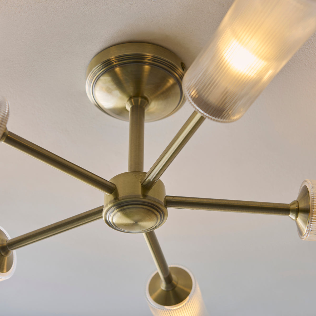 Underside detail of the Avelyn light's brass centre hub and radiating arms