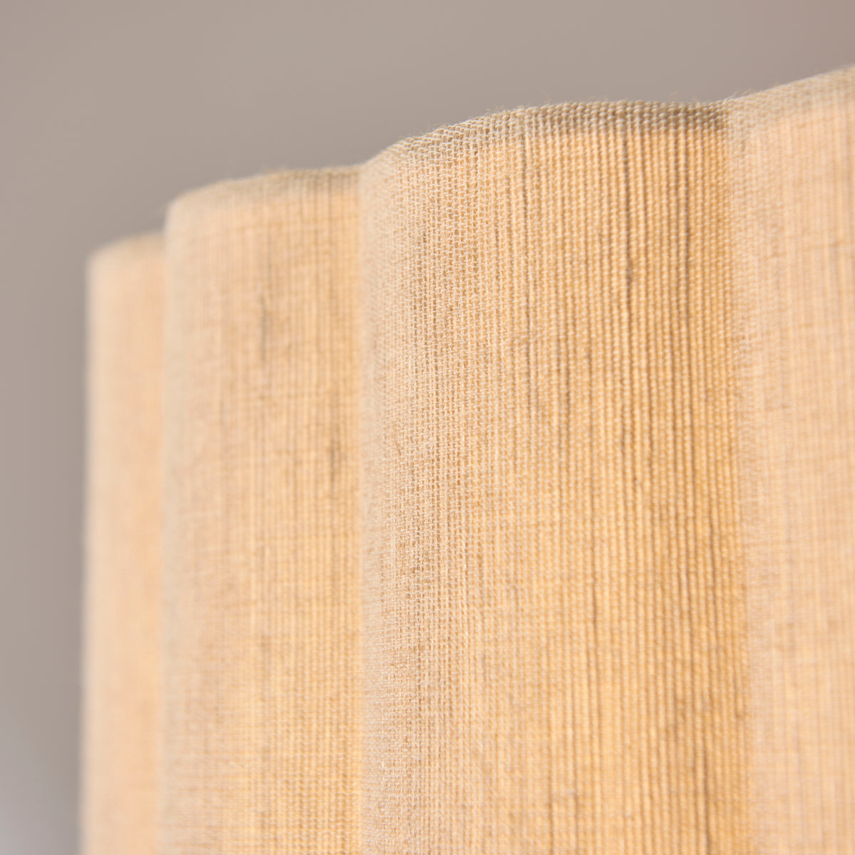 Detail of the woven natural fabric and scalloped pleats on the Olson pendant shade