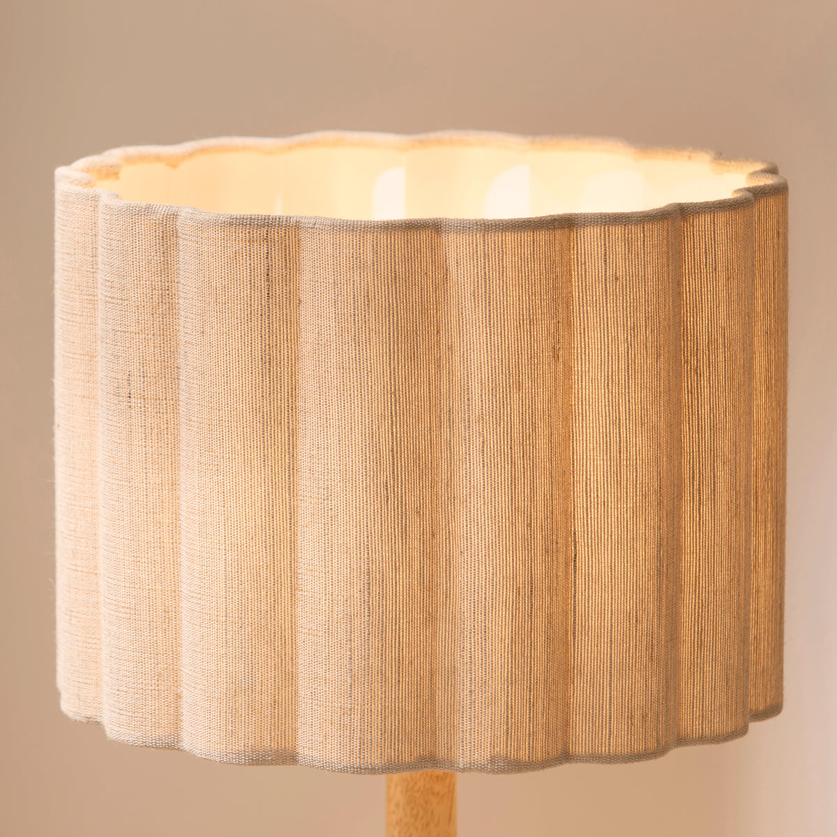 Close-up of the Olson shade's scalloped natural fabric ridges and bright cream inner lining