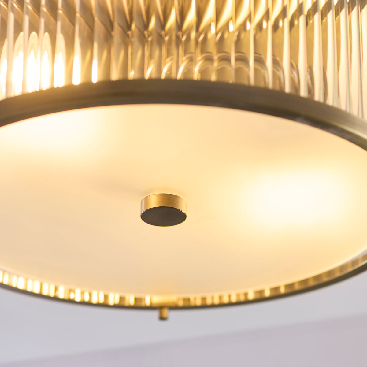 Detail of the Ridgeton fitting's opal glass diffuser and brass finial seen from underneath