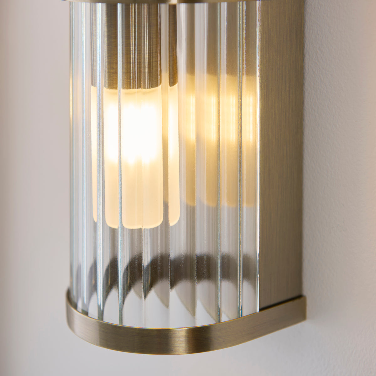 Detail of the Ridgeton light's fluted glass and curved antique brass base plate