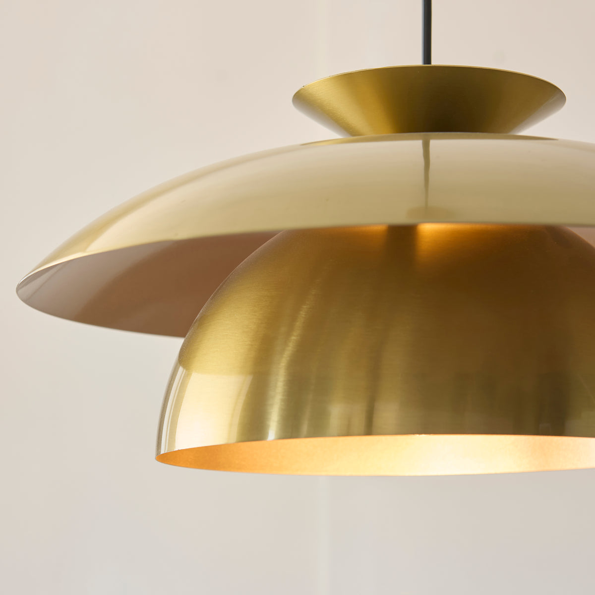 Close-up of the Lyon pendant's glowing brass-lined inner dome