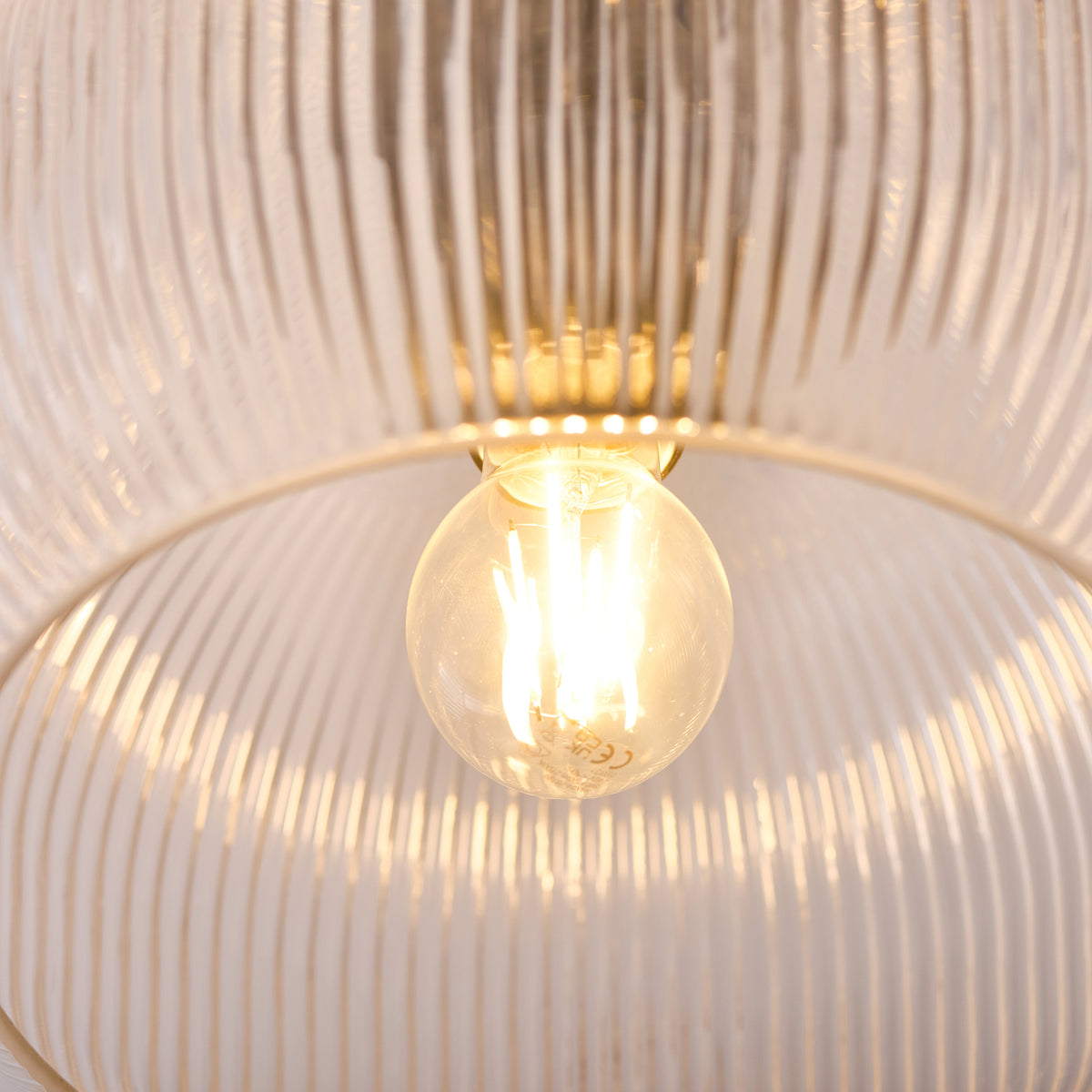Close-up of the globe filament lamp inside the Harborne ribbed glass shade