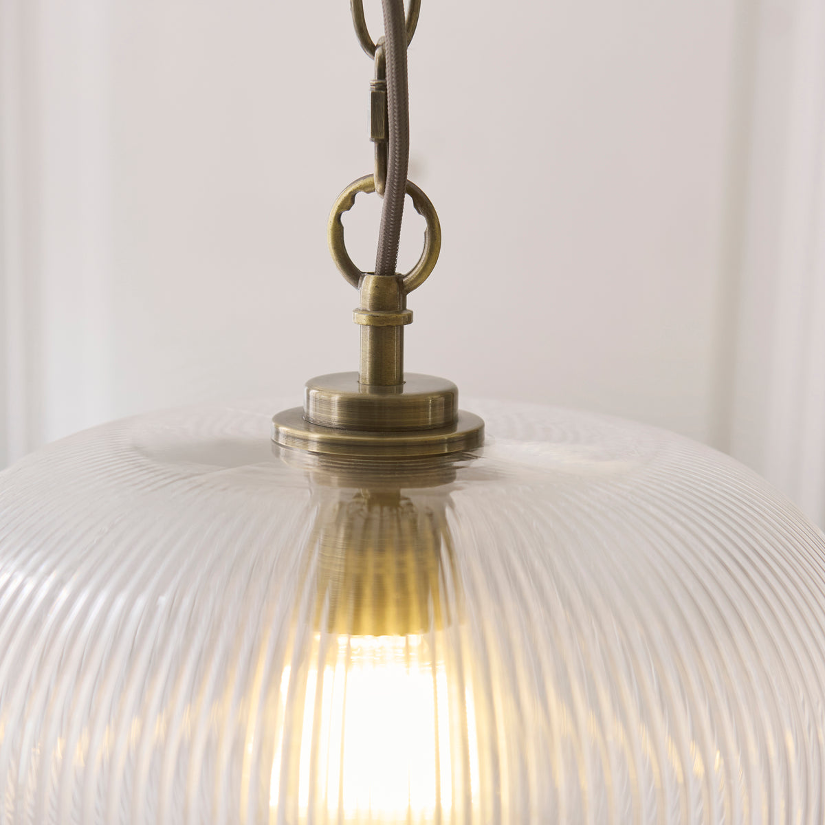 Detail of the antique brass gallery, ring and chain at the top of the Harborne ribbed glass pendant
