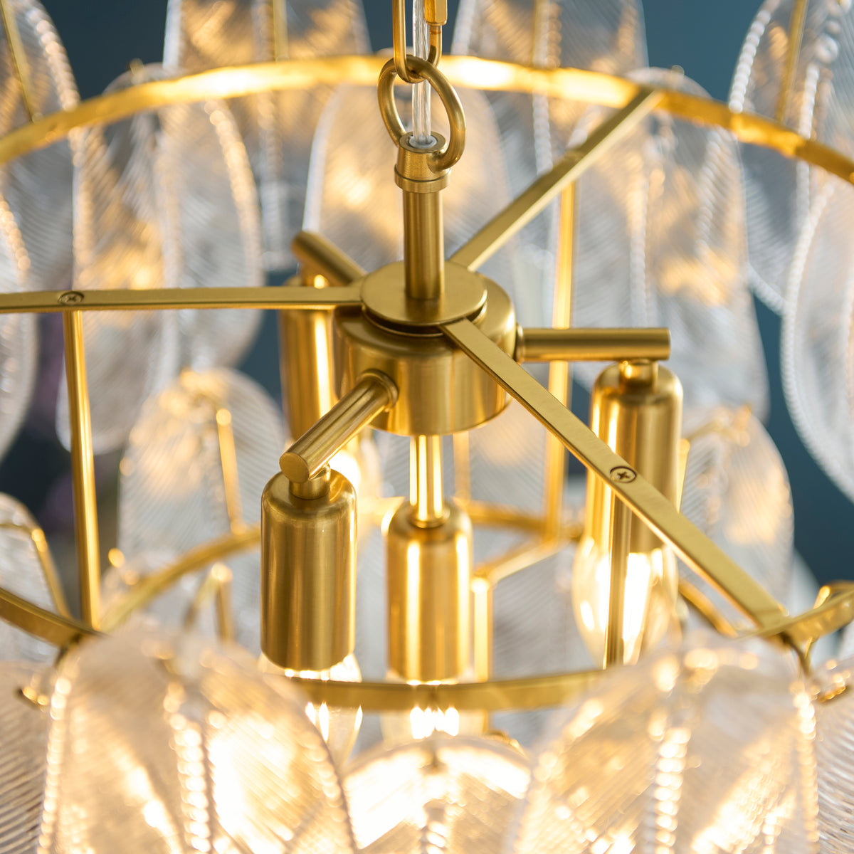 Brushed aged brass frame and lamp holders at the centre of the Autumn glass leaf chandelier