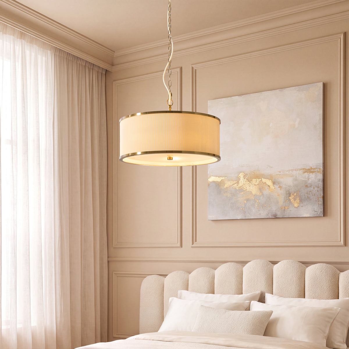 Lexi ivory drum pendant lit above a cream upholstered bed in a panelled bedroom with abstract art