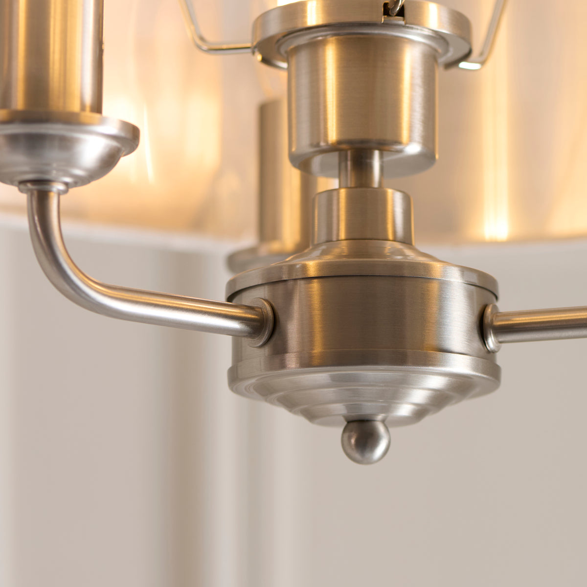 Close-up of the Highclere light's brushed chrome central boss and curved arms