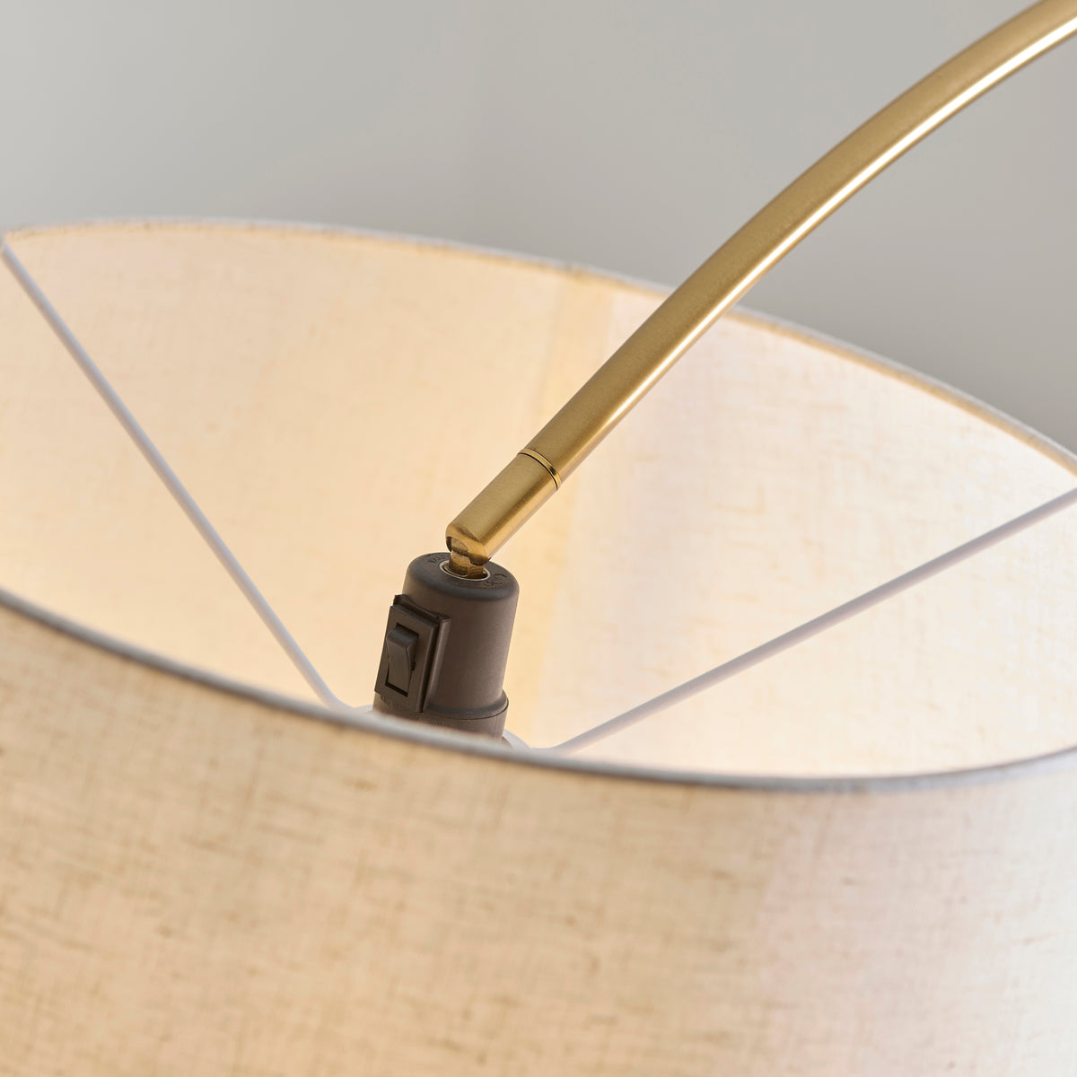 Close-up of the adjustable brass joint where the Carlson XL arch meets its linen shade