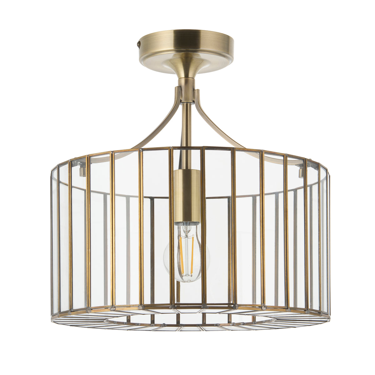 Antalya antique brass flush ceiling light with glass cage shade shown against white