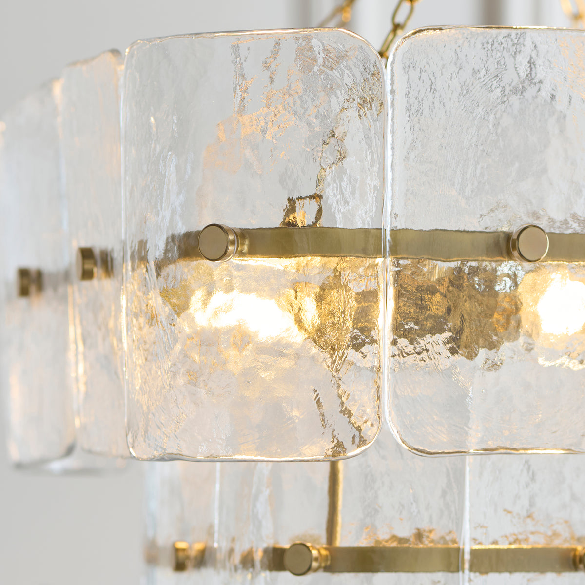Detail of the Venice pendant's handmade glass tiles fixed to aged brass rails