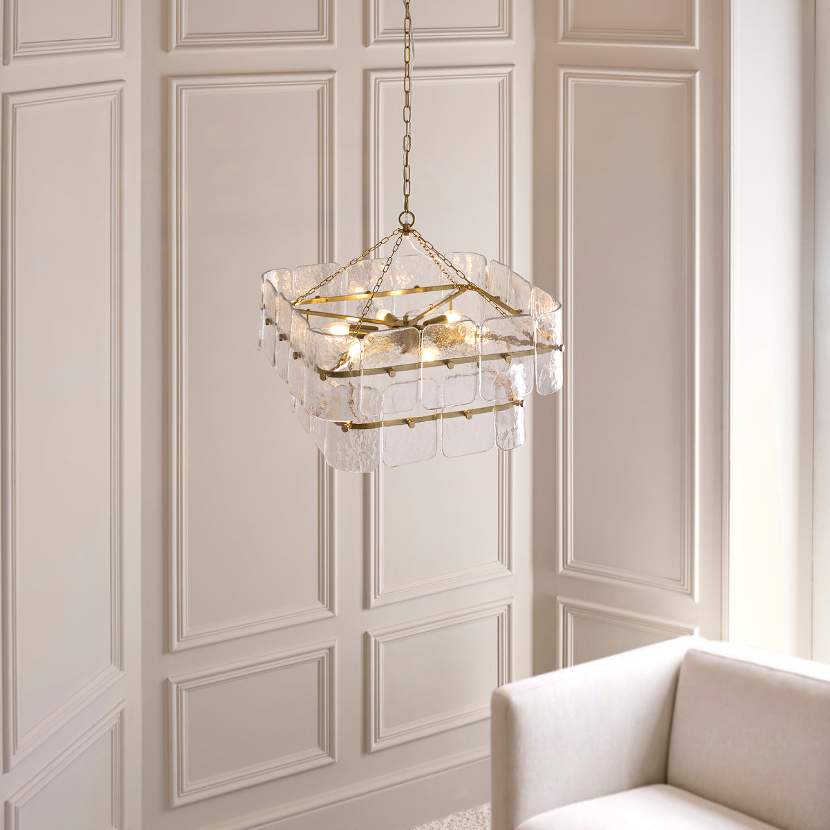 Venice brushed brass and glass pendant hanging beside pale wall panelling