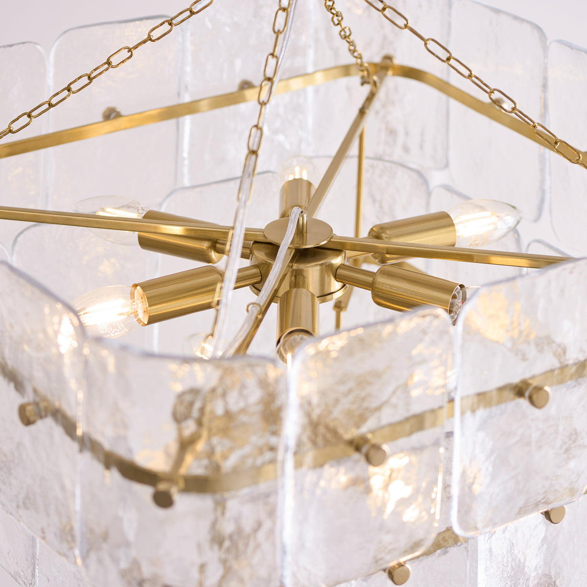 Interior view of the Venice chandelier showing its brass lamp holders and candle bulbs