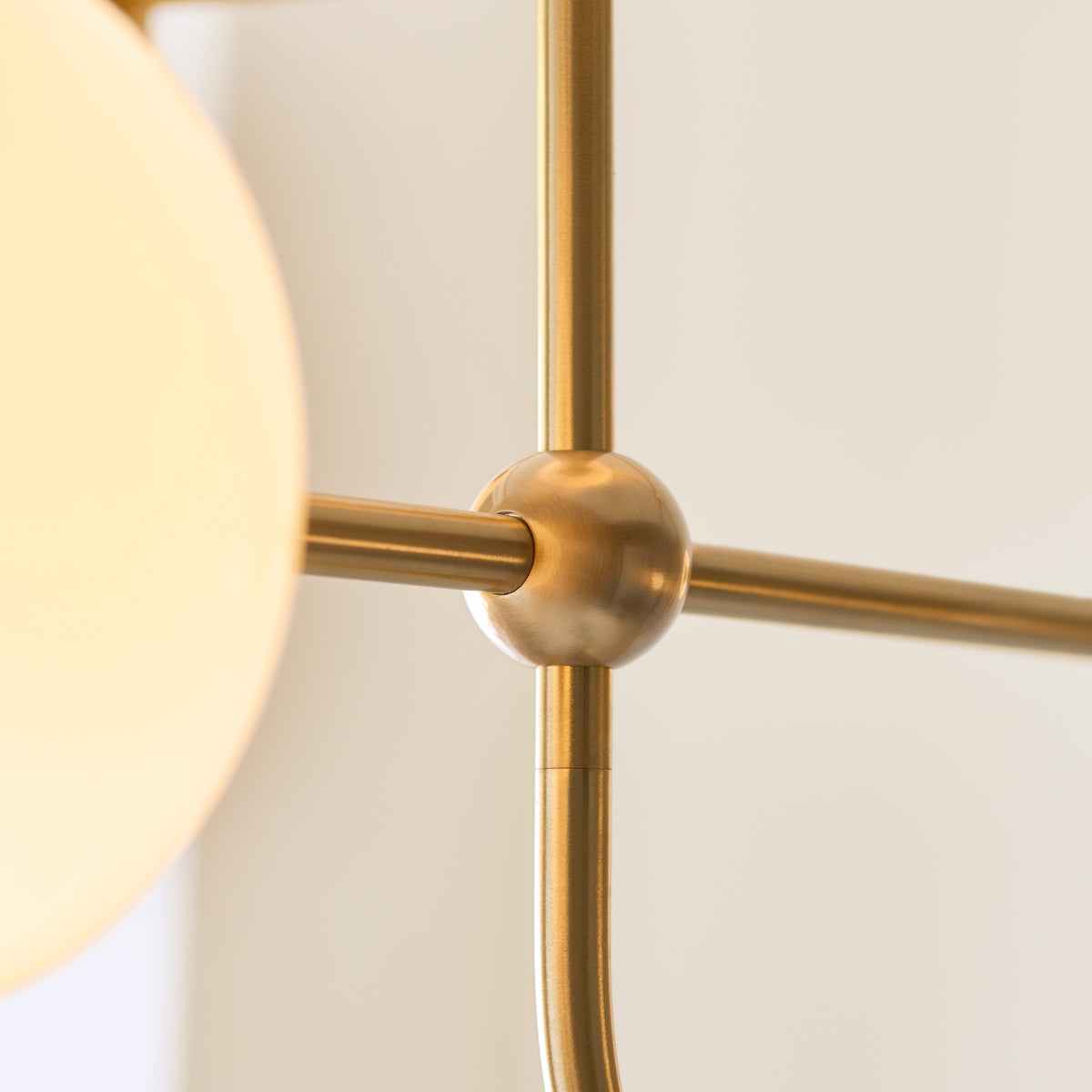 Brass ball joint detail where the Ottowa pendant's slim arms cross