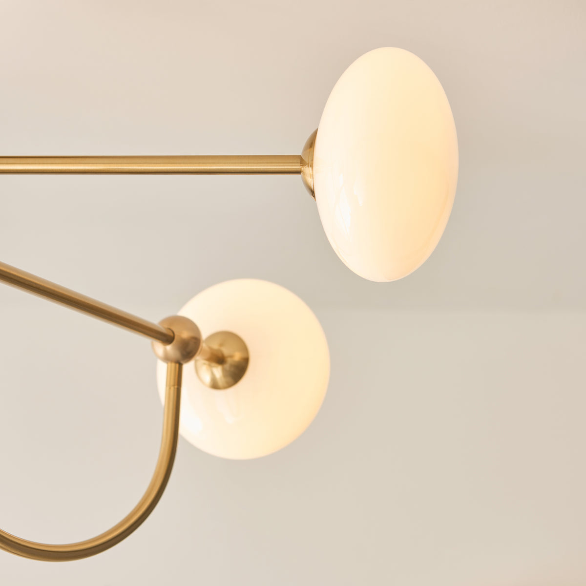Detail of an opal glass shade and brass fitting on the Ottowa semi flush ceiling light