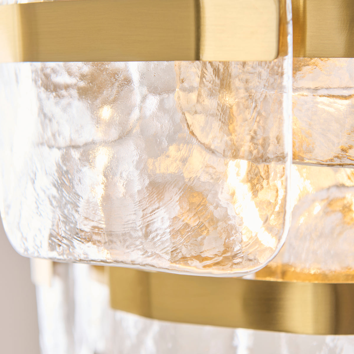 Detail of a single mottled glass panel and brass band on the Ancara pendant