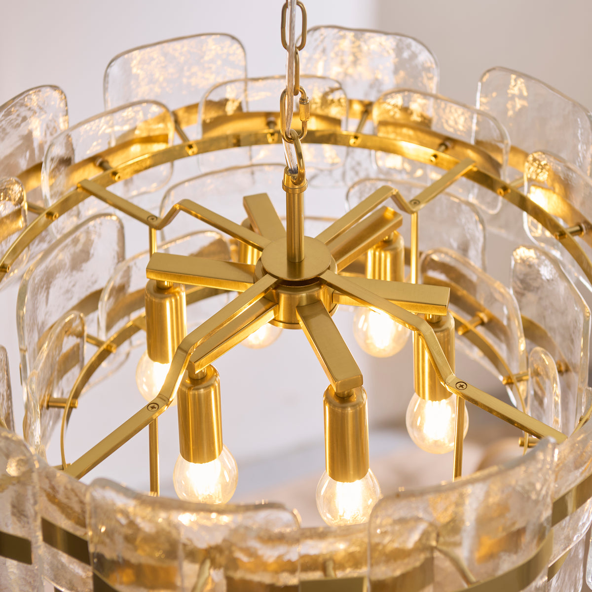 Interior of the Ancara chandelier showing brass lamp holders and lit filament bulbs