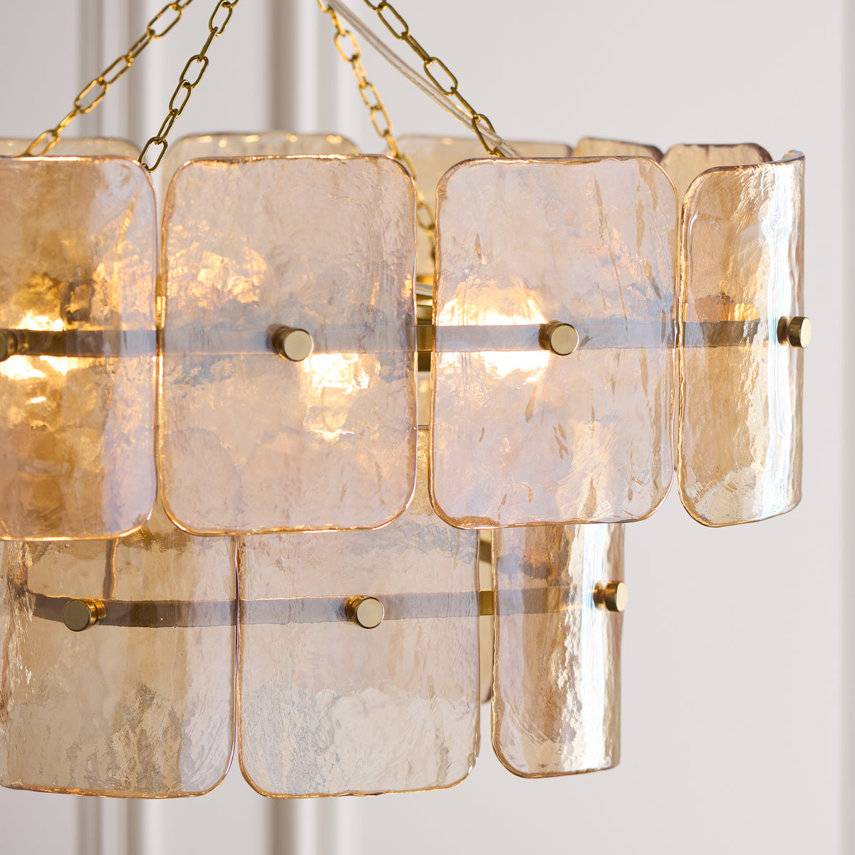 Close-up of the Venice chandelier's mottled champagne glass panels and brass fixings